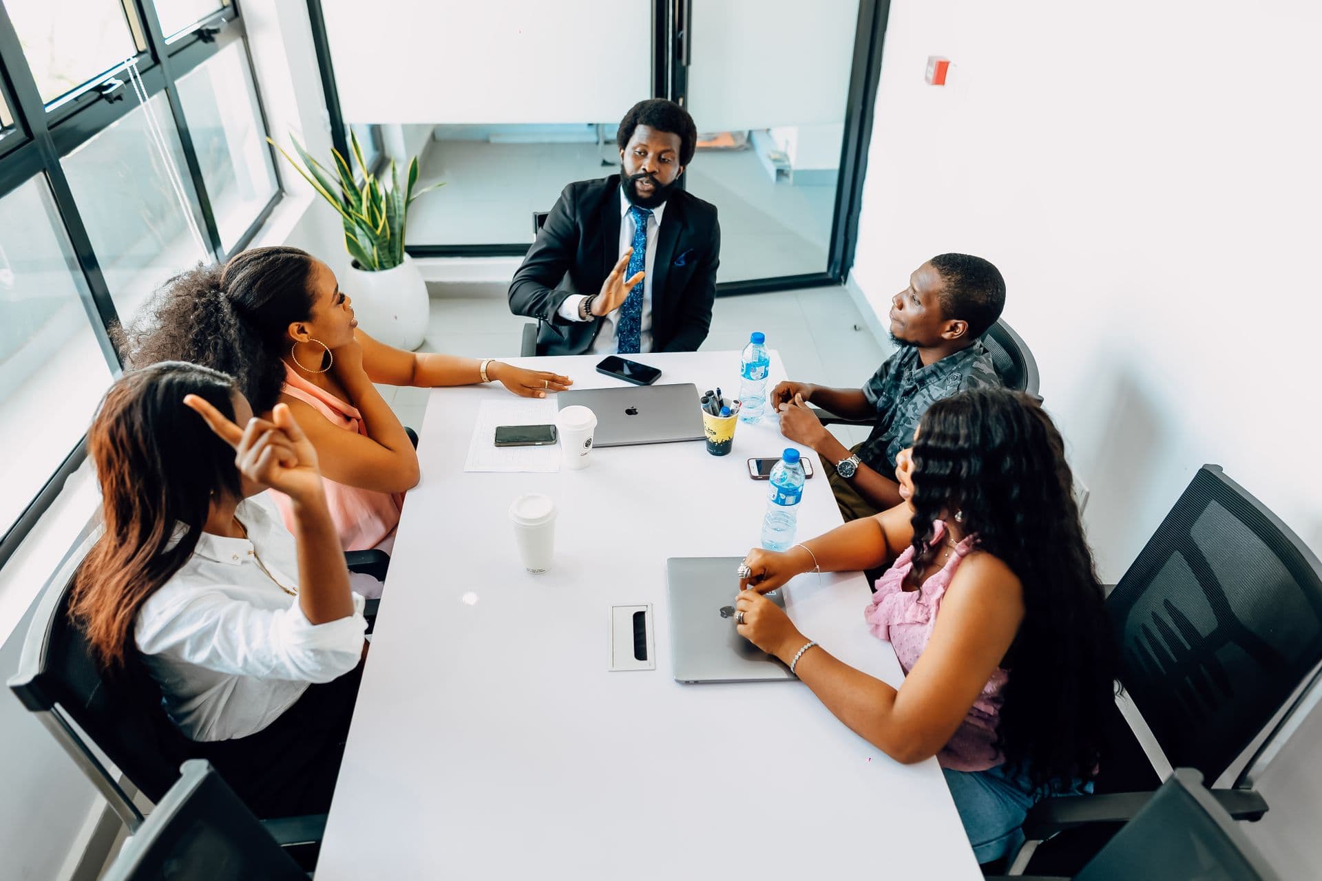 A public-health administrator briefing colleagues in a programme meeting.