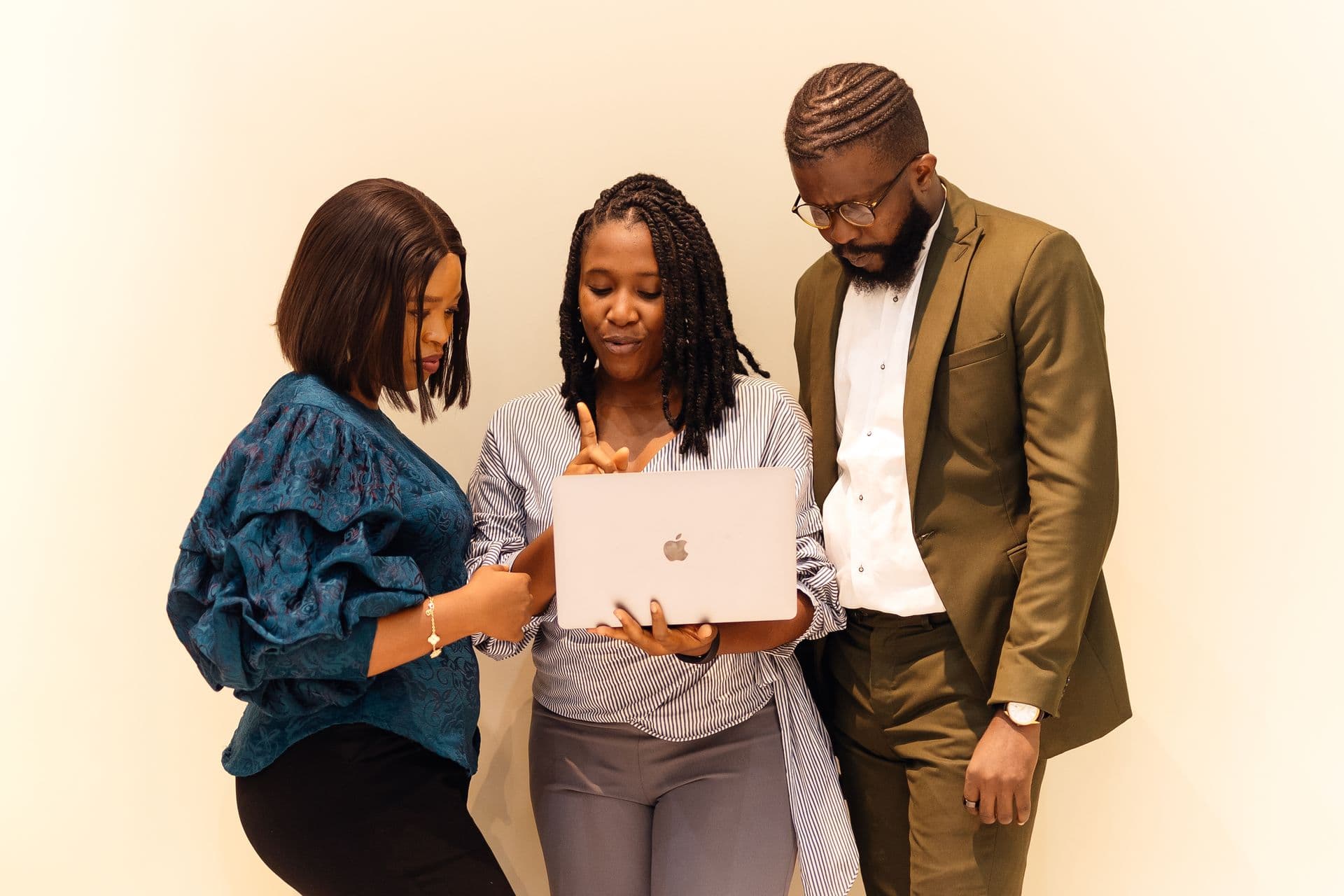 Surveillance officers reviewing a case together on a laptop.